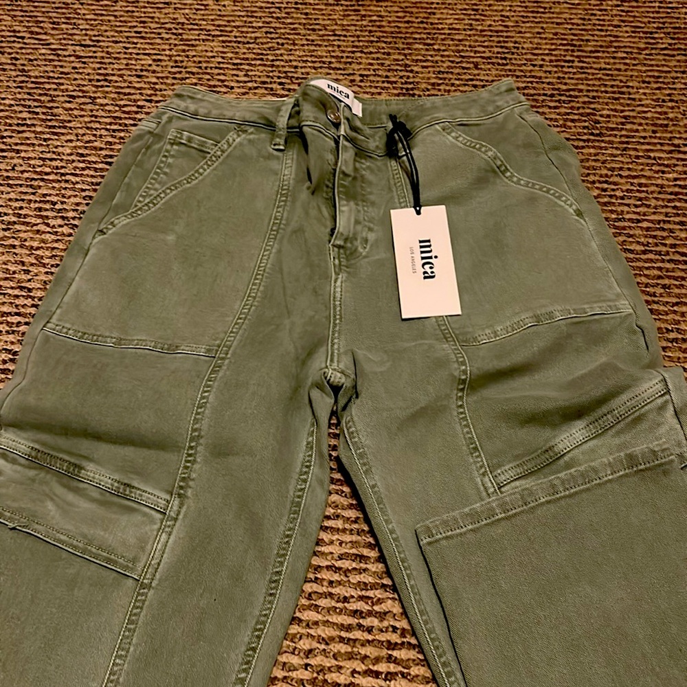 Colored denim Sz. 29. Front pockets, pockets on legs, and back pockets.
